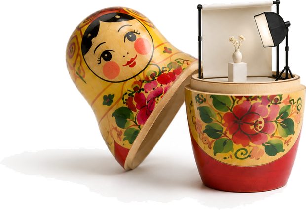A doll opened, a lit photography set inside it